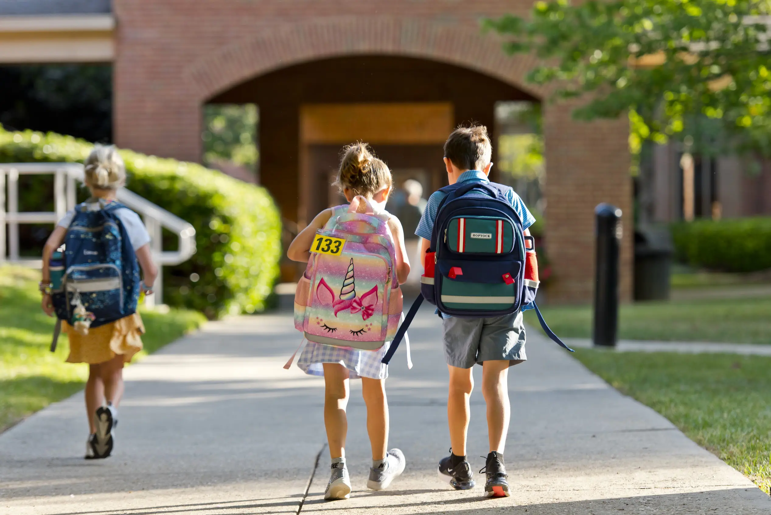 Lower school student walking into the school's building