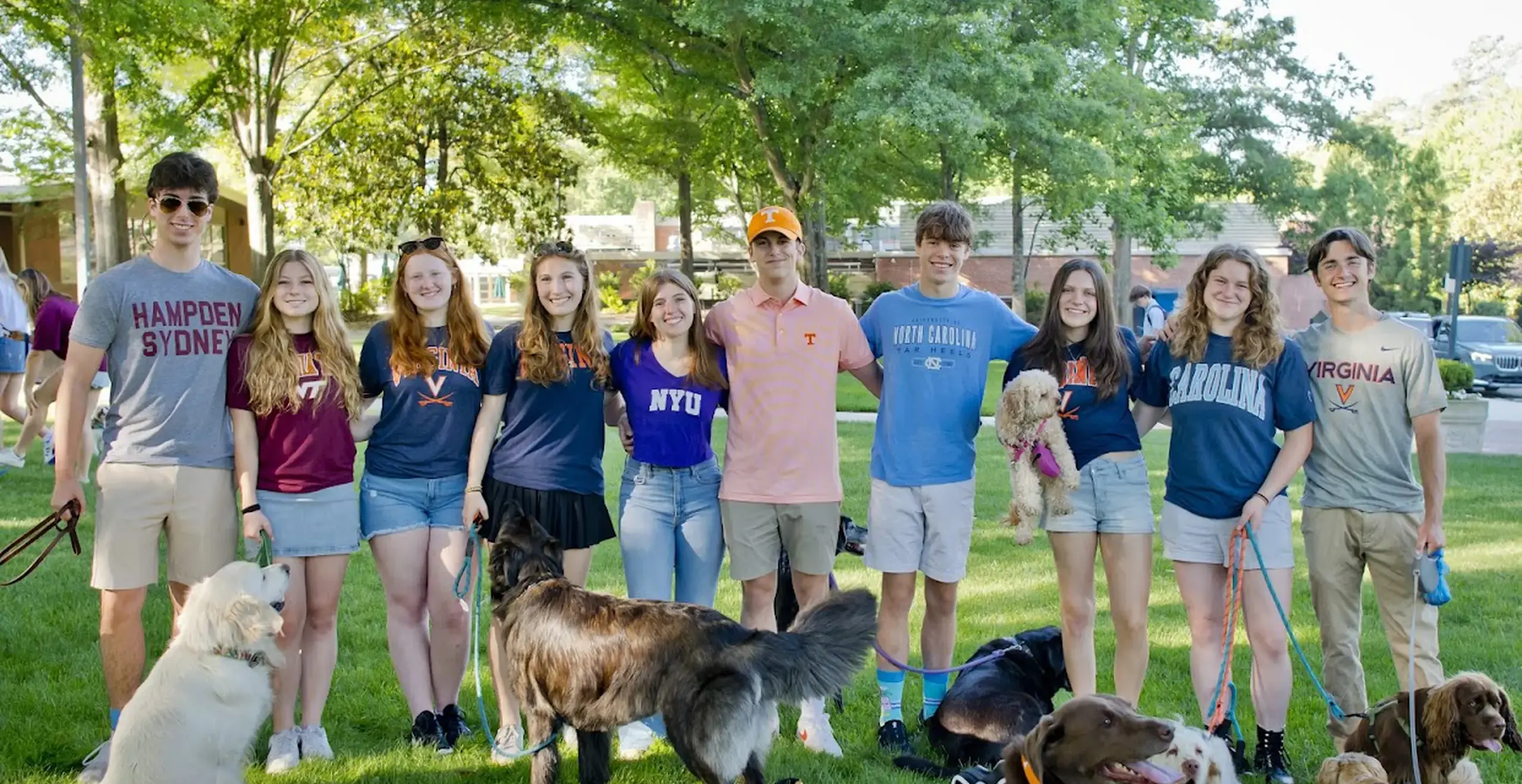 Group of students smiling with their dogs