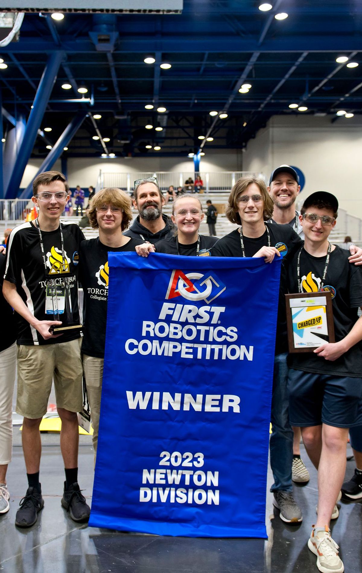 Students holding a winner banner
