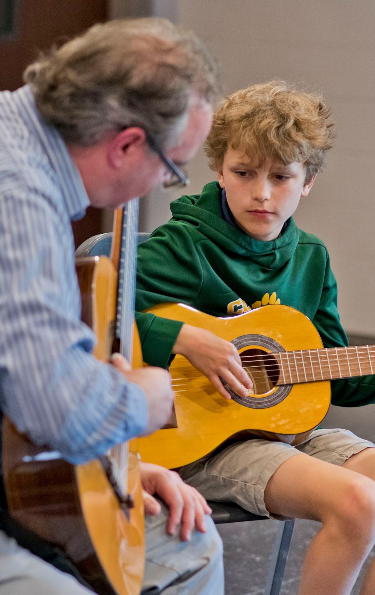 Student learning how to play guitar