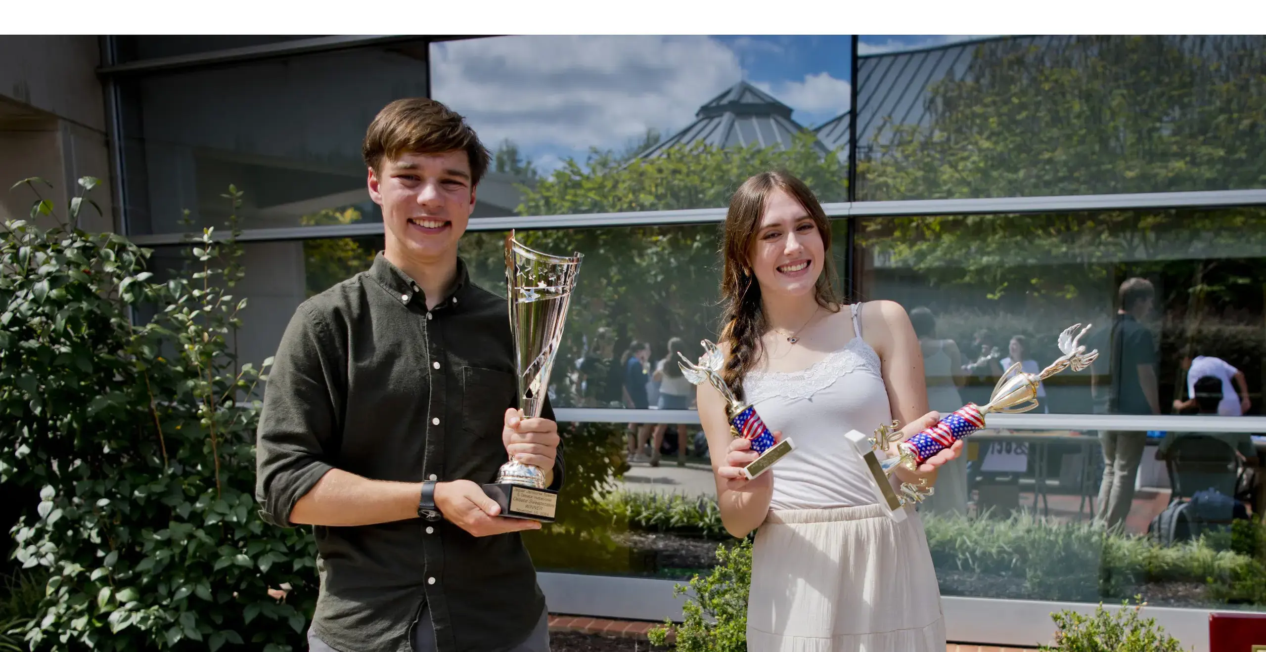 Students holding their trophies 
