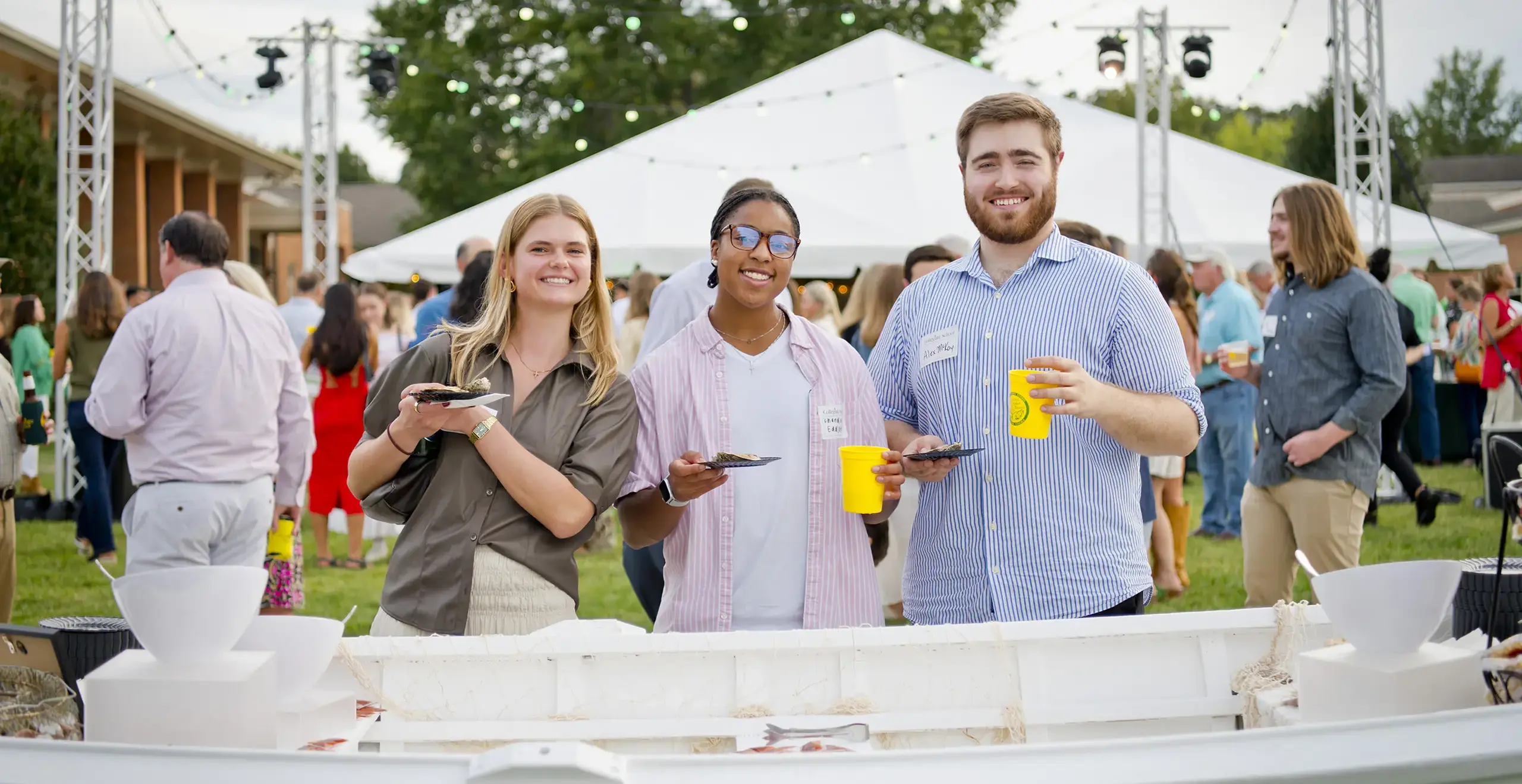 Alumni smiling during an event