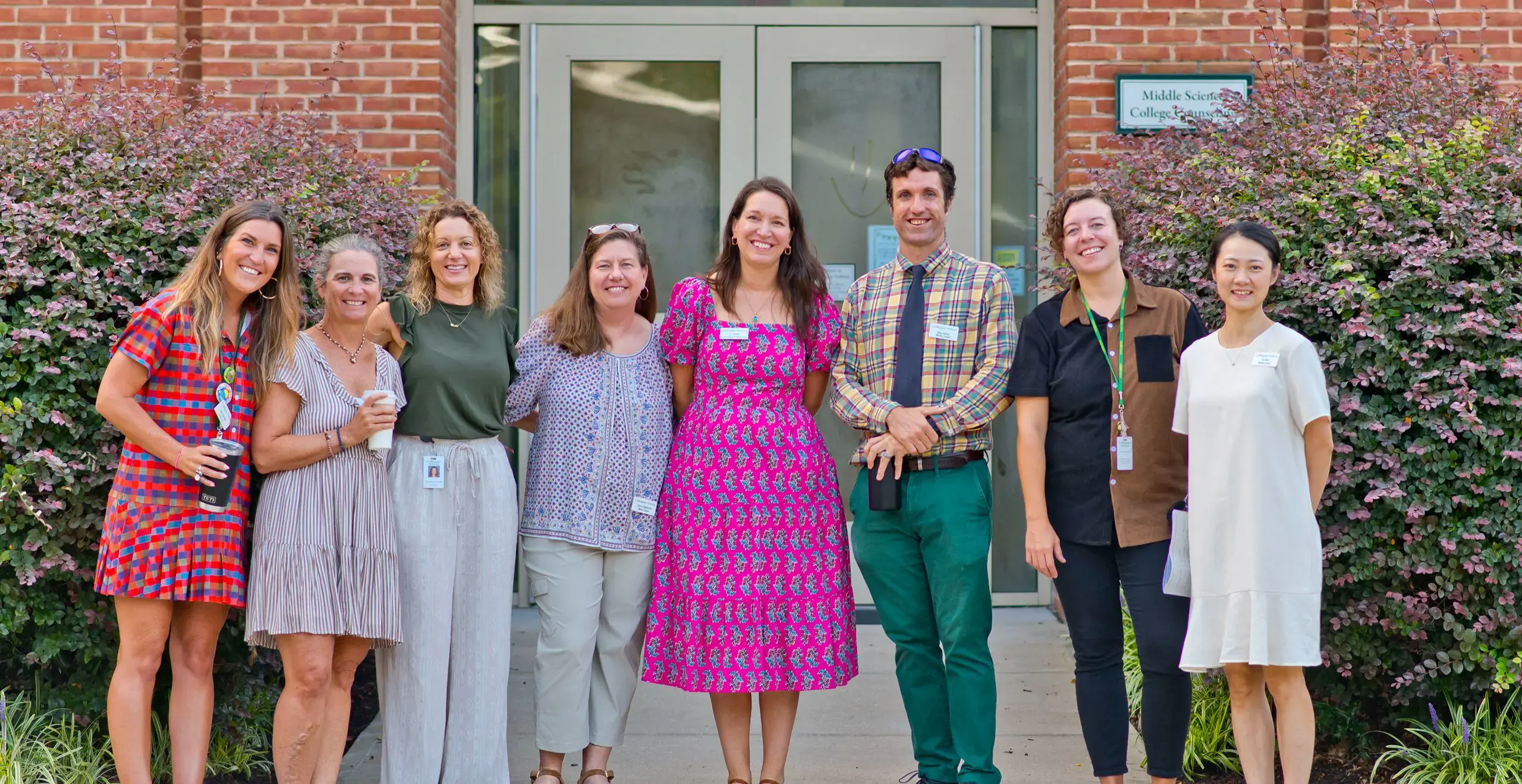 Faculty staff smiling in a group picture