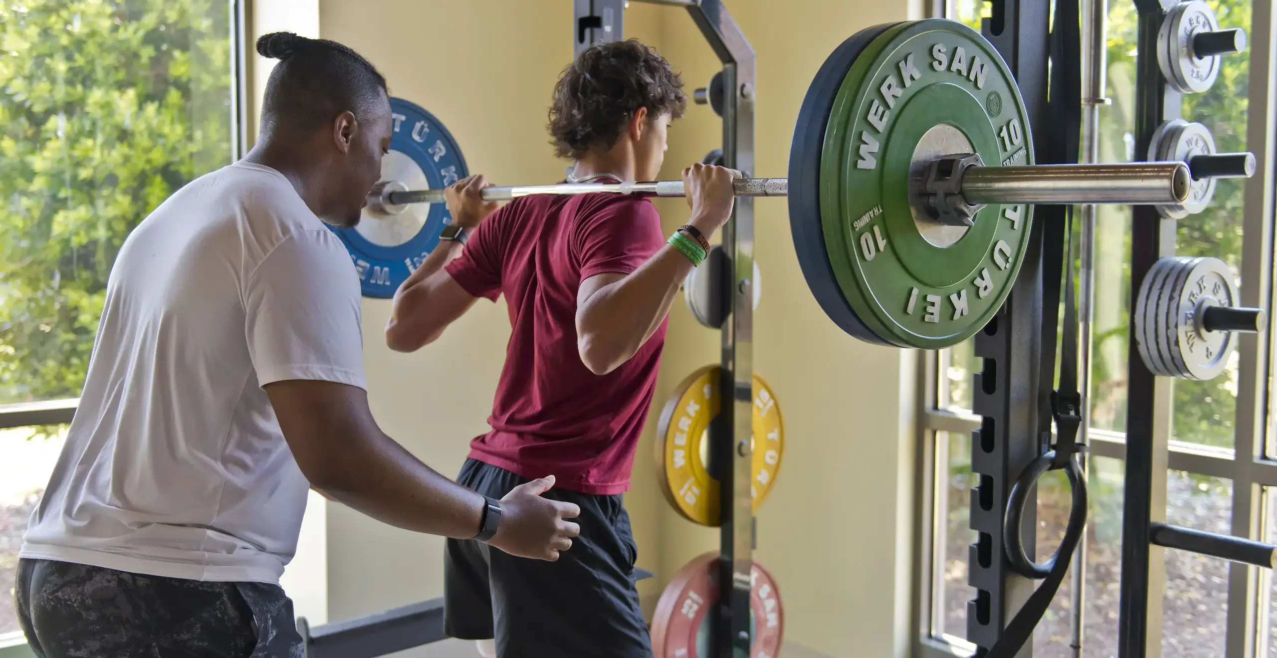 Students training with weights in the school gym