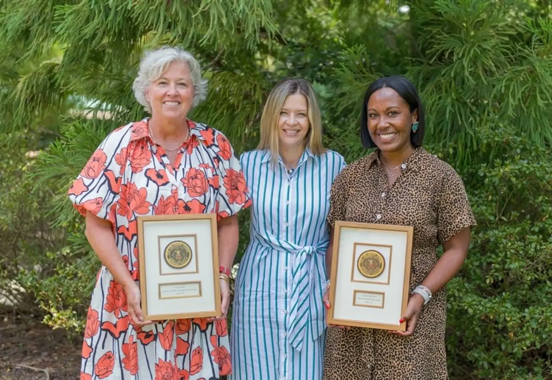 teachers showing their awards