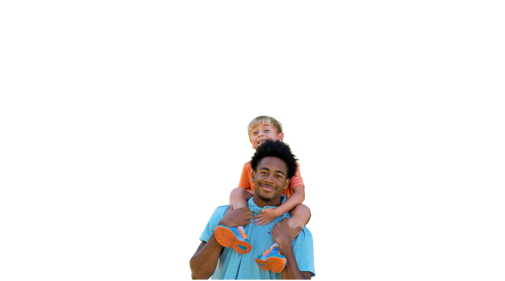 Teacher giving a Lower School student a piggyback ride