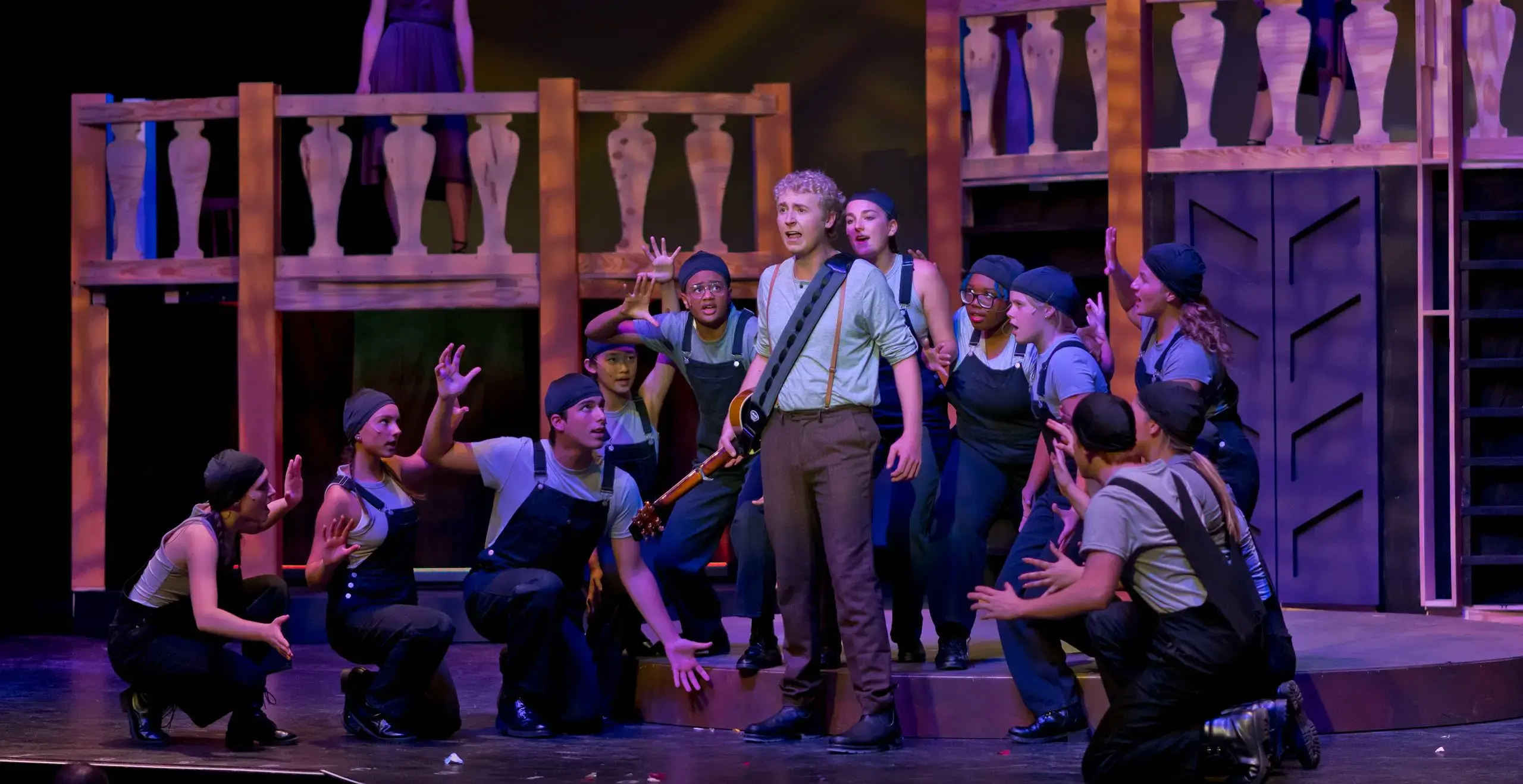 Group of students performing on stage during a play.