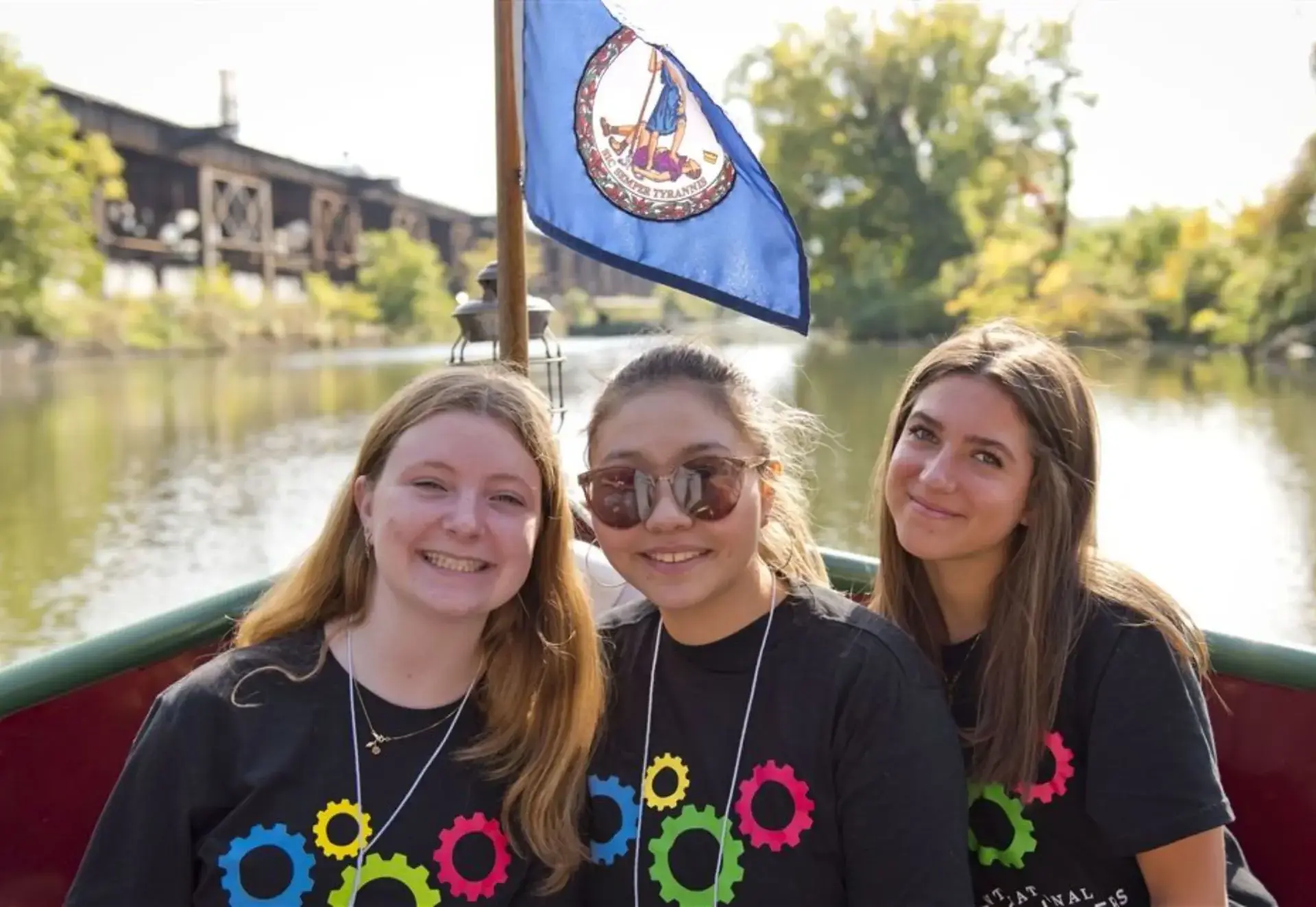 students smiling on a boat