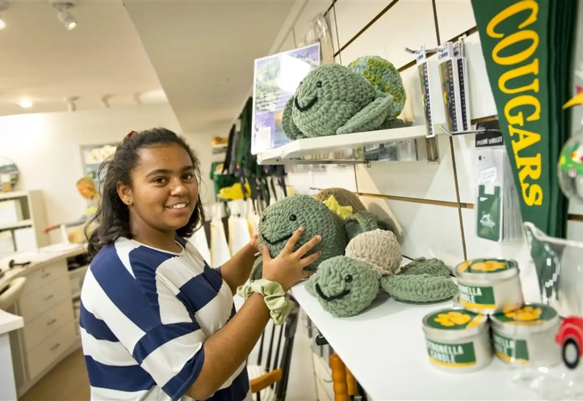 Addison showing her crocheted turtles