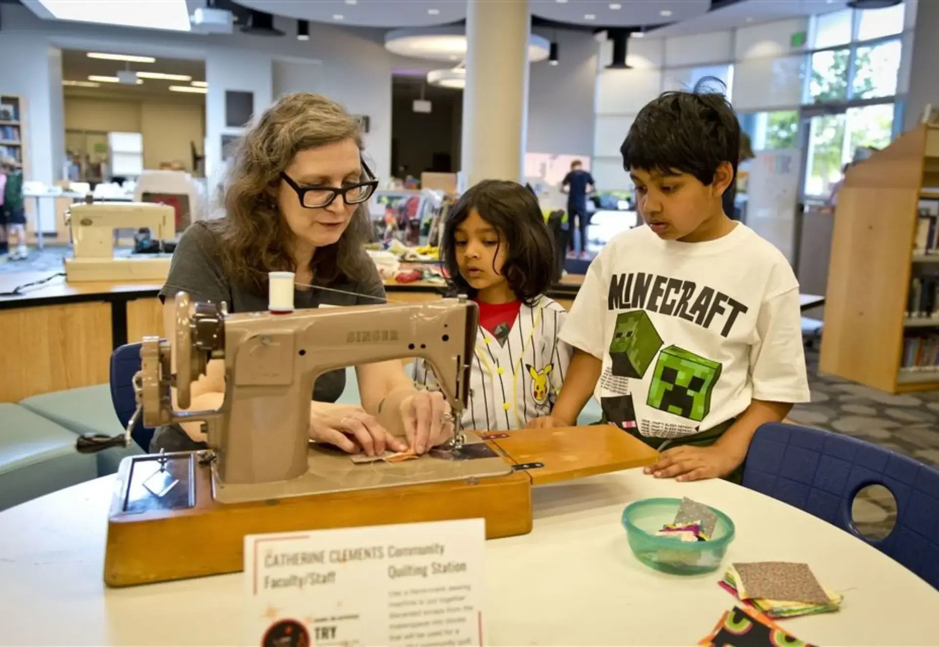 Catherine Clemens showing students how to sew