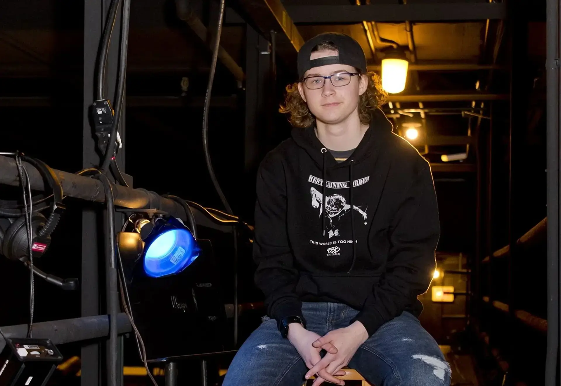student sitting backstage