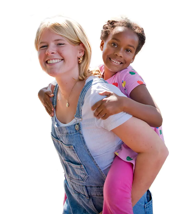 A senior and kindergarten student happily engage.