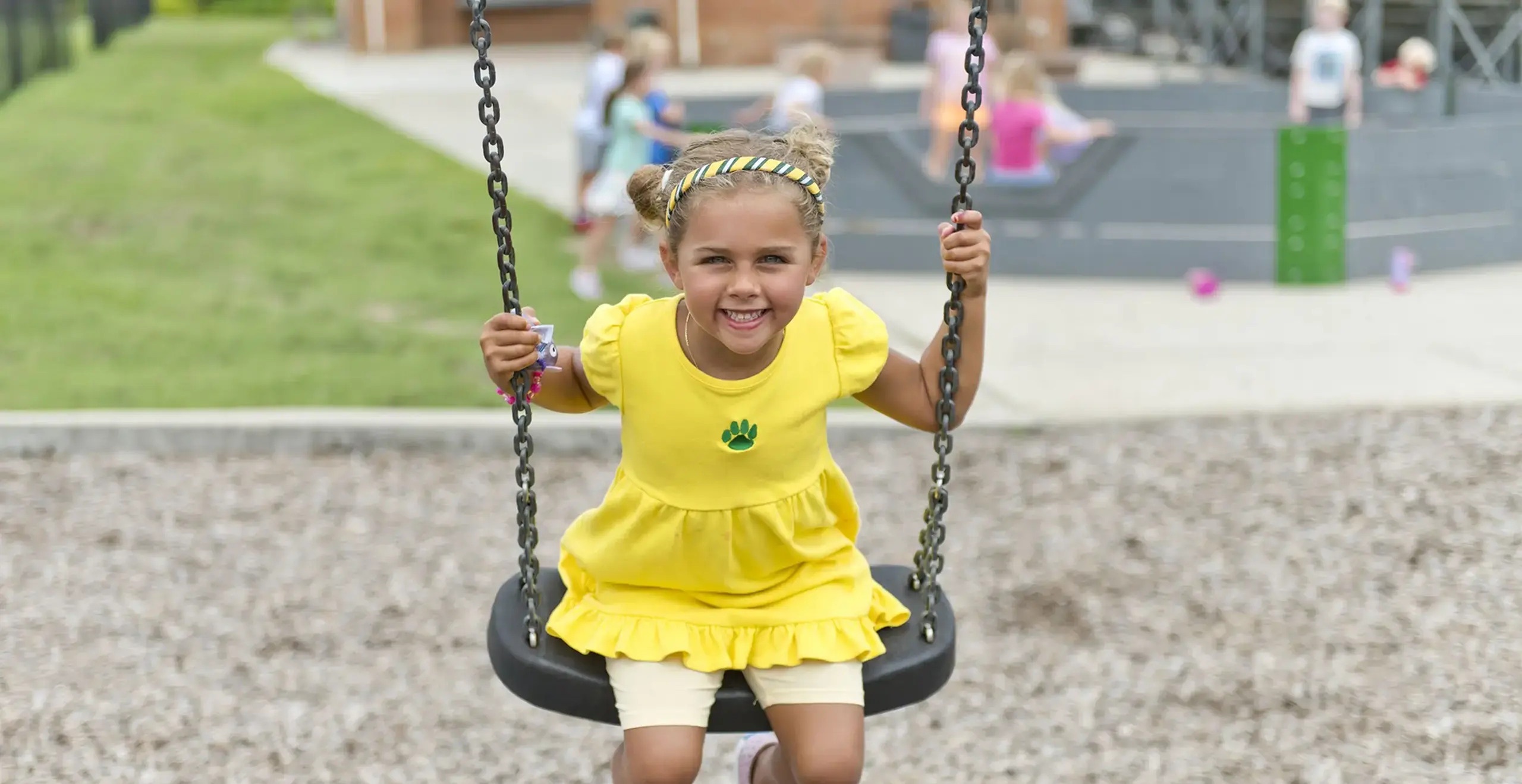 Student playing in a swing